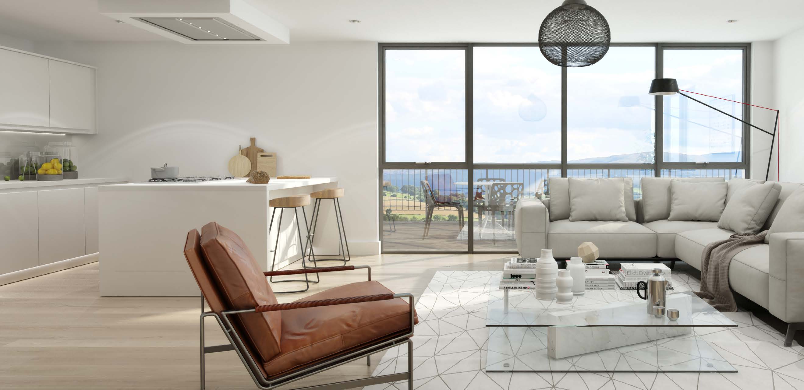 A bright coastal living room with dark aluminium framing and a sea outlook, from Senior’s brochure