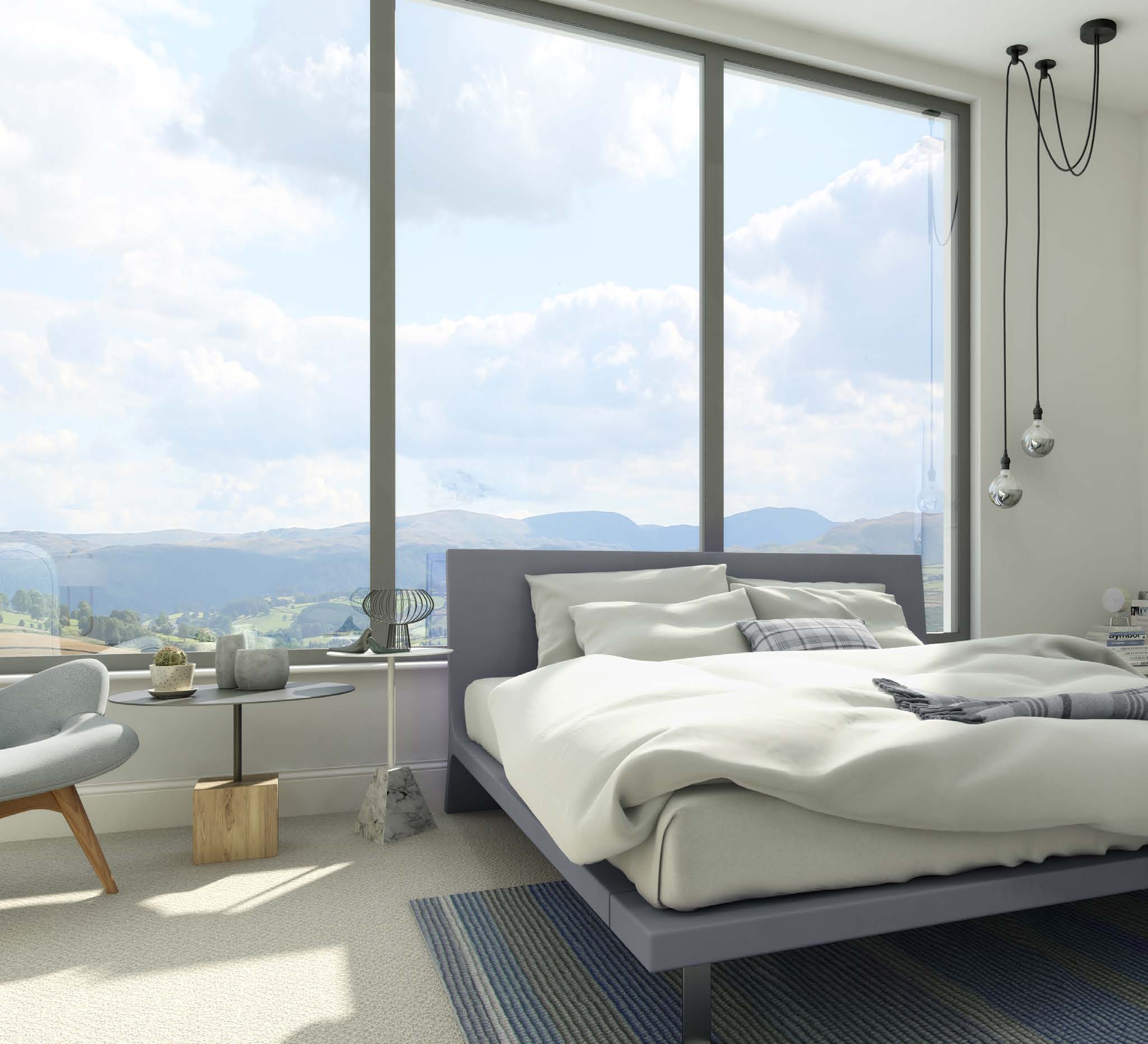 Large aluminium-framed bedroom glazing overlooking green hills, from Senior’s brochure